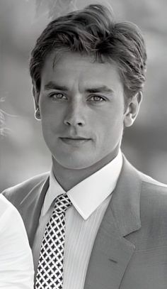 a black and white photo of a man in a suit