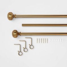 three brass door handles and some hardware on a white surface