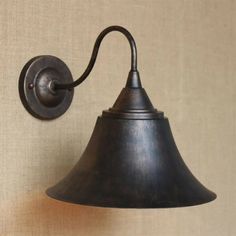 an old - fashioned wall light is hanging on the wall in front of a beige background