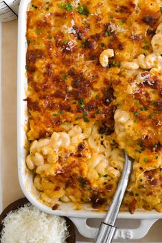 a casserole dish with macaroni and cheese in it next to rice