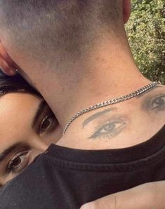 a man and woman with tattoos on their neck