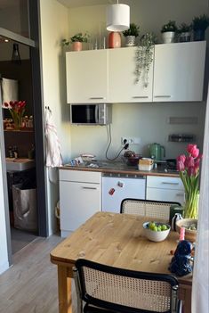 a kitchen with a wooden table and white cabinets