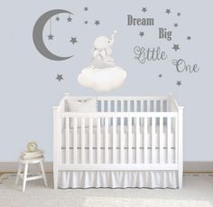 a baby's room with a white crib and stars on the wall