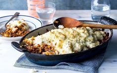 a casserole dish with mashed potatoes and meat in it on a table