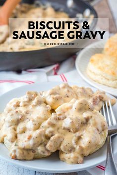 biscuits and sausage gravy on a white plate with a fork next to it