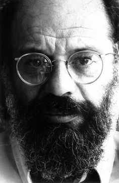 a black and white photo of a bearded man with glasses, bow tie and beard