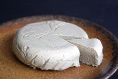 two pieces of white cheese on a brown plate