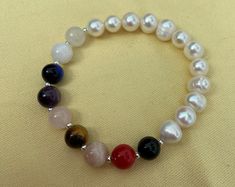 Enjoy the good vibes of a Lucky, Healing & Energizing  9 Chakras  bracelet made with 100% Authentic Gemstones. The bracelet is composed of 9 crystals and pearls, 8mm each:  Onyx (Earth Chakra) Red Coral (Root Chakra), Sunstone (Sacral Chakra), Tiger Eye (Solar Plexus Chakra), Rose Quartz (Heart Chakra), Amethyst (Throat Chakra), Lapis Lazuli (Third Eye Chakra), Moonstone (Crown Chakra) and Clear Quartz (Soul Star Chakra). The stones are specially collected in order to unlock, activate and balanc 7 Chakras Bracelet, Chakra Chip Bracelet, Rainbow Healing Bracelet Hand-strung, Seven Chakras Bracelet, Meditation Hand-strung Agate Crystal Bracelet, Chakra Racine, Love And Pride, Rose Quartz Heart, Solar Plexus Chakra