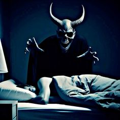 a person in bed with an evil mask on their head and hands out to the side