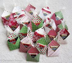 a pile of small red and green christmas gift bags