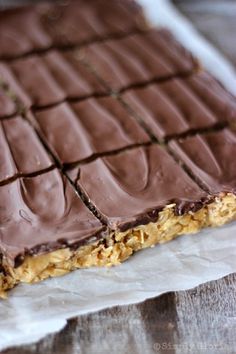 a close up of a chocolate bar on a piece of parchment paper with no one around it