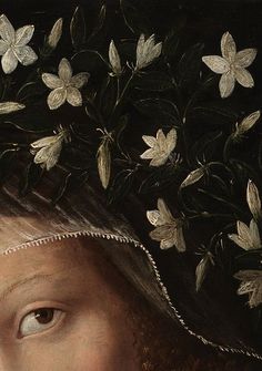 a close up of a woman's head with flowers on it