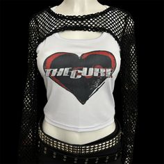 * Sublimated 1980s gothic post punk new wave band heart cropped tank top * Mannequin is wearing size L * Mannequin measurements:    * Bust: 35" (C cup)    * Waist: 26"    * Hip: 40" * Soft, breathable, and stretchy material * For a looser fit, size up * Please note that all items are Made to Order & there may be slight variations in appearance Stretch Punk Crop Top For Streetwear, Punk Graphic Print Crop Top For Spring, Spring Punk Style Graphic Print Crop Top, Spring Punk Crop Top With Graphic Print, Fitted Grunge Tank Top With Graphic Print, Stretch Grunge Graphic Print Crop Top, Y2k Style Tank Top For Concerts, Fitted Emo Tops For Spring, Fitted 90s Tank Crop Top