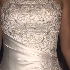 the back of a wedding dress with beading and sequins on it's waist