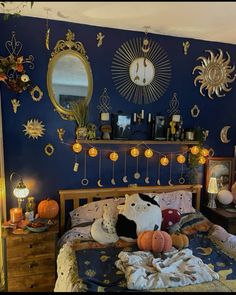 a bedroom decorated for halloween with pumpkins on the bed and decorations hanging from the wall