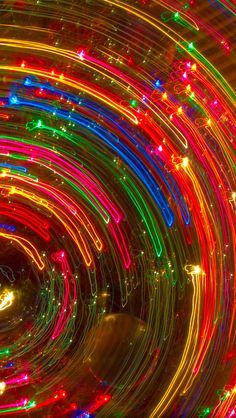 an image of colorful lights in the night time tunnel with long exposure and motion blurs