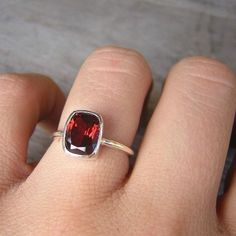 Red Garnet January Birthstone Ring for Her, Garnet Cushion Ring, Garnet Solitaire Ring, Christmas Gift for Her Garnet Ring, Red Garnet January birthstone, Birthstone Jewelry, Cushion Shape, Solitaire This deep red garnet ring features this rectangular cushion cut gemstone set in a sterling silver ring. The color of this gemstone is deep and bright red at once, full of bright red fire, sometimes a flash of peachy orange shows up in the sunlight. A gorgeous red cocktail ring that will get you comp Cushion Cut Ruby Jewelry Gift, Cushion Cut Ruby Jewelry As Gift, Cushion Cut Ruby Jewelry For Gift, Red Rectangular Gemstone Jewelry, Red Gemstone Jewelry With Rectangular Stone, Red Rectangular Stone Jewelry Gift, Red Rectangular Stone Jewelry For Gifts, Red Square Cut Gemstone Jewelry, Elegant Rectangular Garnet Rings