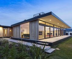 a modern house with glass walls and sliding doors