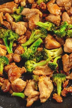 chicken and broccoli stir frying in a wok with sauce on the side