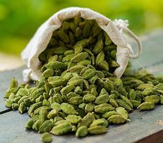 a bag filled with green seeds sitting on top of a wooden table