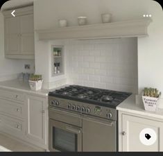 a kitchen with an oven, range and counter tops in the middle of it is shown