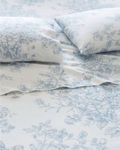 the blue and white bedding has flowers on it