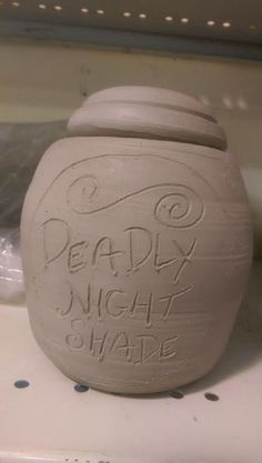 a ceramic jar that says deadly night made