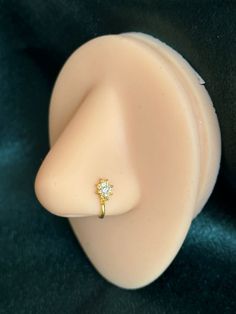 a close up view of a ring on top of a plastic head with a black background