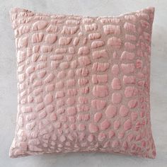 a pink pillow on a white wall with an animal print pattern in the middle and bottom