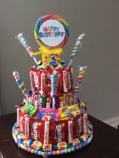 a birthday cake made out of candy and lollipops