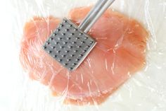 a piece of meat with a grater in it on top of some plastic wrap