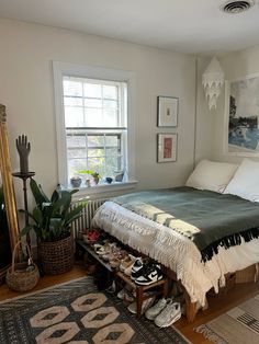 a bedroom with a bed, rugs and pictures on the wall above it's headboard