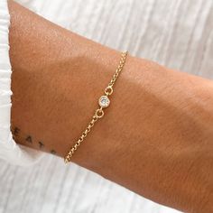 * A B O U T * O U R * B R A C E L E T* CZ BRACELET This lovely bracelet features a delicate circle CZ, crafted with 18K gold plating. Adjustable and simply dainty, it's perfect for everyday wear. The minimalist design makes it ideal for layering with other bracelets, adding a touch of sparkle to any outfit. * D E T A I L S * * 18K Gold Plated * Tarnish Free * Adjustable ∙ ∙ ∙ ∙ ∙ ∙ ∙ ∙ ∙ ∙ ∙ ∙ ∙ ∙ ∙ ∙ ∙ ∙ ∙ ∙ ∙ ∙ ∙ ∙ ∙ ∙ ∙ ∙ ∙ * E T S Y * S H O P MORE SOLID GOLD EARRINGS: https://www.etsy.com/sh Tiny Bracelet, Gold Arm Band, Cz Bracelet, Gold Armband, Solid Gold Earrings, Minimalist Bracelet, Dainty Bracelets, Dainty Jewelry, Beautiful Packaging