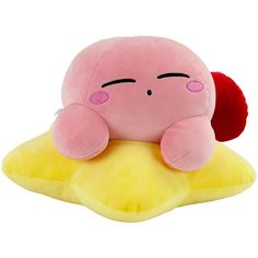 a pink stuffed animal laying on top of a yellow pillow