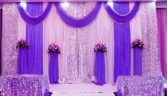 a purple and white wedding setup with flowers