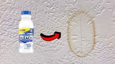 a bottle of mouthwash next to a toothbrush on a white wall with peeling paint