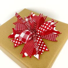 a present wrapped in brown paper with red and white polka dots on it's bow