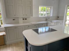 a large kitchen with white cabinets and an island