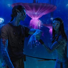 two people standing in front of an underwater scene