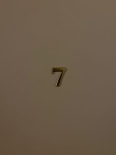 the number seven is shown in gold on a white background