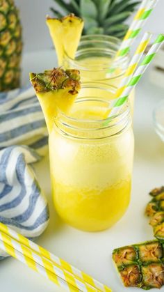 pineapple drink with two straws in mason jars