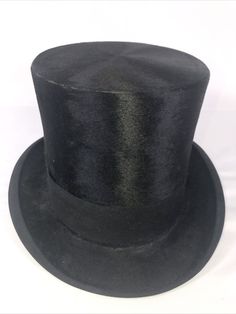 Vintage John Cavanagh Ltd. Black Silk Fur Felt Top Hat. The size tag is missing!!! It is about 7 1/2. For actual size, please see pictures for reference!!!! Signs of wears as shown. There is a scuff on top brim. There are some scuffs on bottom brim ( see photos) I am not sure what year this hat was made. Saw one site showing the inner label being used in the late 1920s but have no way to verify. Approximate measurements: it is 12” from front to back. 9” from side to side, and 5.6”-6” tall. Pleas Black Formal Short Brim Hat, Formal Black Short Brim Hat, Black Top Hat With Short Brim For Formal Occasions, Formal Black Brimmed Costume Hats And Headpieces, Black Formal Costume Hat With Curved Brim, Formal Black Brimmed Costume Hat, Formal Black Costume Hats With Curved Brim, Black High Crown Hat For Formal Occasions, Black High Crown Costume Hat For Formal Occasions