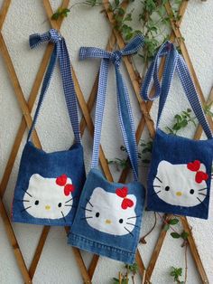 two hello kitty purses hanging on a wall