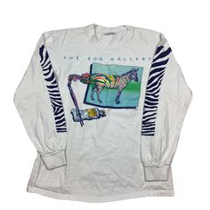 Vintage 1983 The Zoo Gallery Long Sleeve Stand Out From The Herd Zebra single, stitch T-shirt. Made in the USA. Double sided graphic. Measures as an XS/XXS. 17 inches pit to pit, 24 inches long. Excellent vintage condition. Smoke and pet free home. 80s single stitch T-shirt. USA made. 90s Graphic Print Long Sleeve T-shirt, 90s Long Sleeve Graphic T-shirt, Vintage Long Sleeve Tops With Graphic Design, Vintage Long Sleeve Graphic Tops, 90s Style White Tops With Vintage Print, Vintage Long-sleeve Graphic Print T-shirt, 90s Long Sleeve Pre-shrunk Tops, 90s Style Long Sleeve Pre-shrunk Top, Vintage White Long Sleeve T-shirt