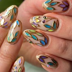 Get inspired with these stunning fall nail art ideas that capture the essence of autumn! From rich burgundy to warm mustard hues, these cozy and stylish designs are perfect for any occasion. Explore easy-to-follow tutorials and unique patterns like leaves, pumpkins, and geometric touches. Whether you’re a DIY enthusiast or visiting a salon, these fall nail trends will keep your manicure game strong all season long. Discover tips and tricks for achieving the perfect fall nails today! Stained Glass Manicure, Asa Bree Nails, Glass Stained Nails, Nail Art Vitrail, Color Pallet Nails, Different Hand Color Nails, Stain Glass Window Nails, Stained Glass Nails Designs, Green Theme Nails