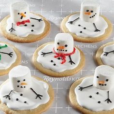 six decorated cookies with frosting and snowmen on them