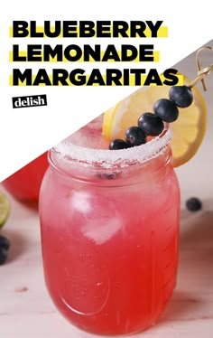 a blueberry lemonade margarita is garnished with blackberries