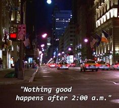 a city street filled with lots of traffic next to tall buildings at night and the words nothing good happens after 28 am