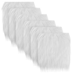 four white furry animal furs lined up in a row on top of each other