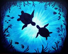 two sea turtles swimming in the blue water